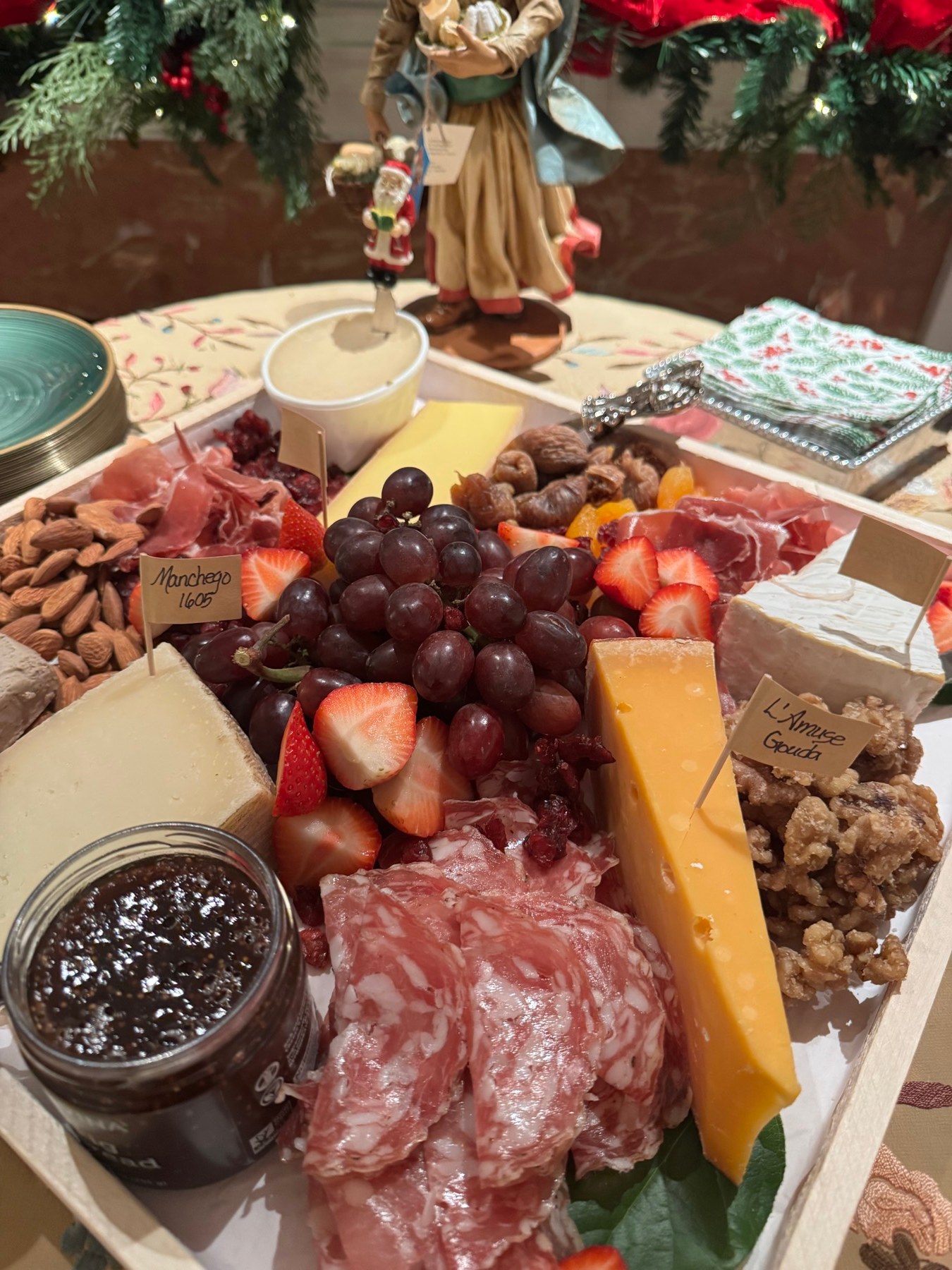 Holiday charcuterie board with cheese, fruit, and cured meats
