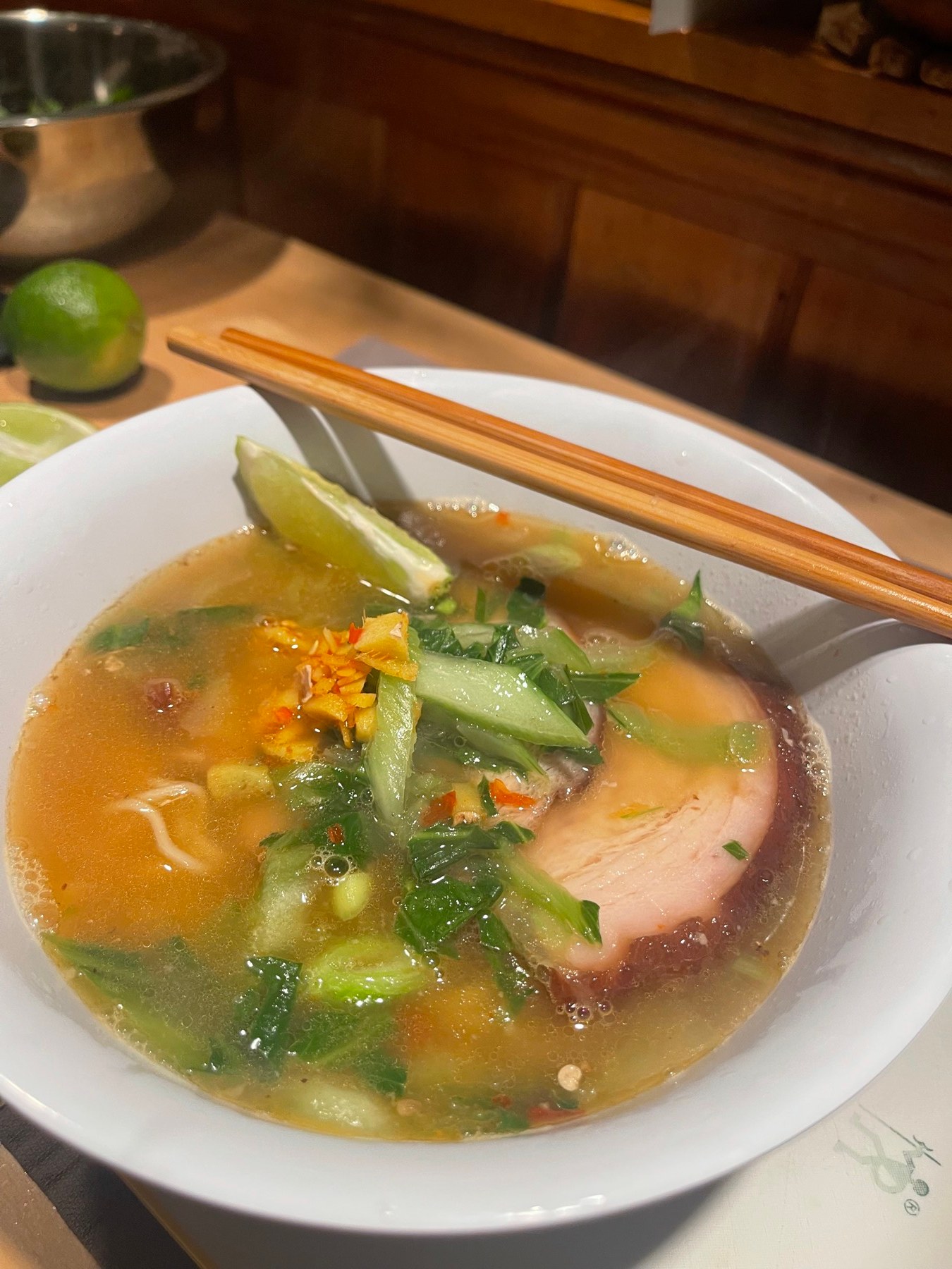 Ramen bowl with greens and lime